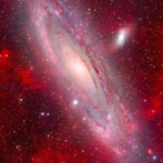 Stunning space photograph captures the majestic Andromeda Galaxy floating in a sea of faint, glowing nebulae |