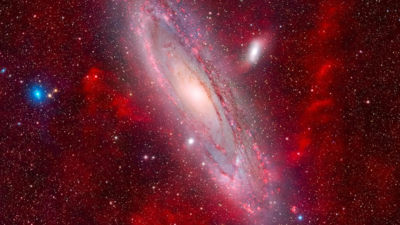 Stunning space photograph captures the majestic Andromeda Galaxy floating in a sea of faint, glowing nebulae |